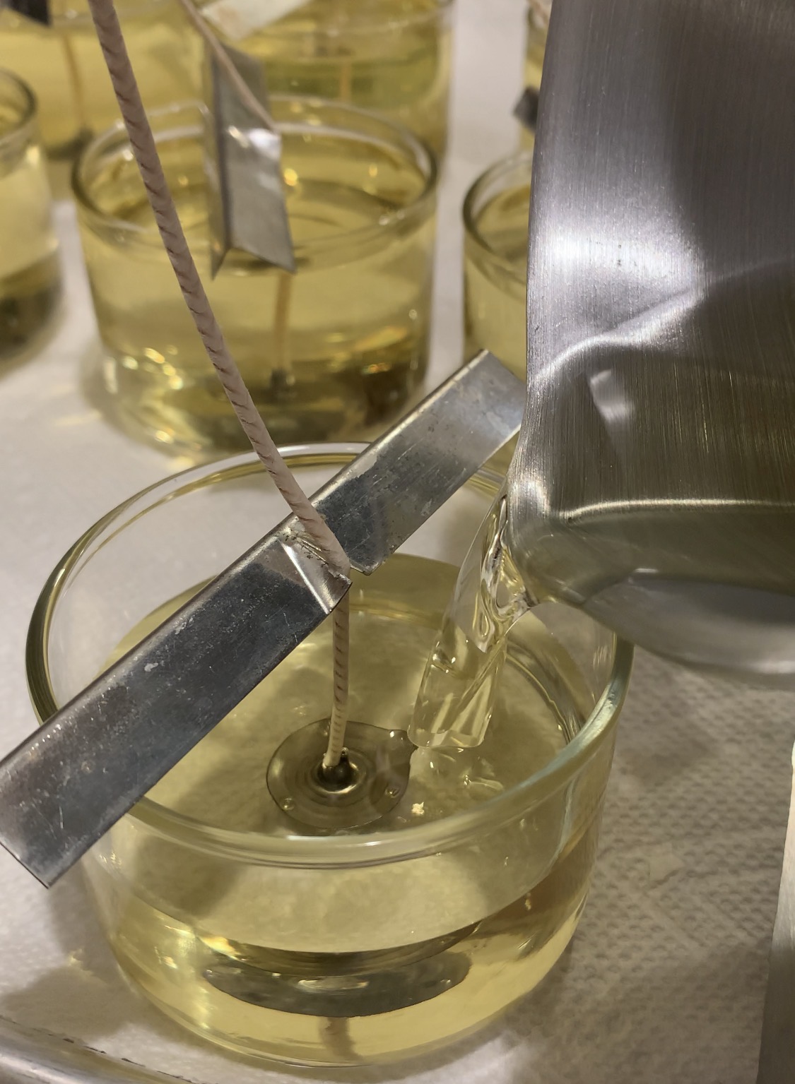 Pouring candle wax into jars